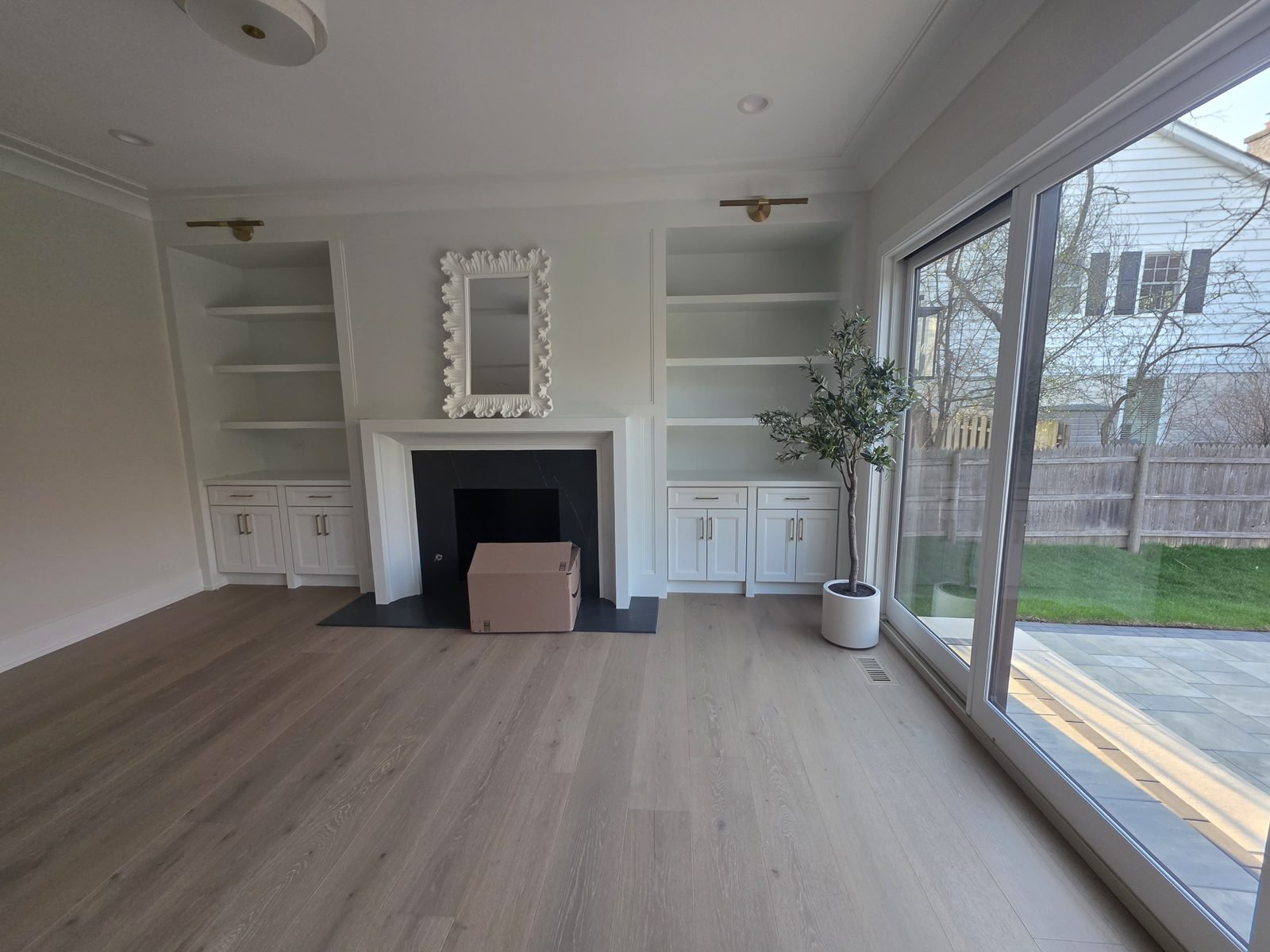 Fireplace surround with built-in shelving and base cabinets on both sides