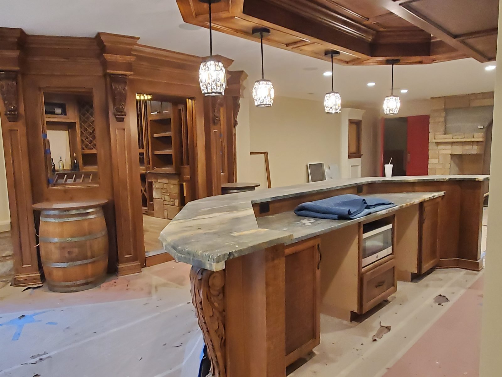 Stained wet bar with carved corbels and a coffered wood ceiling