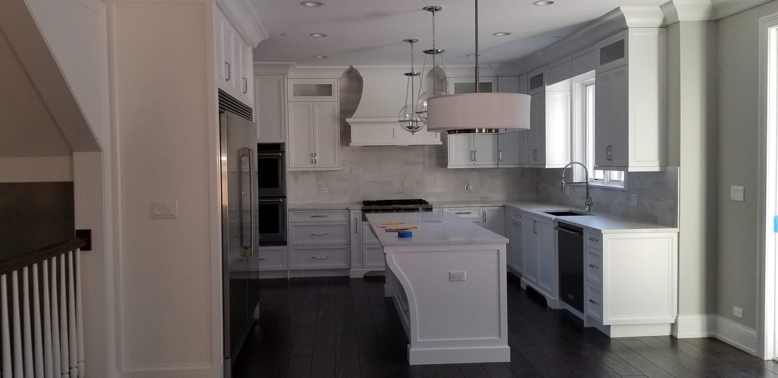White painted kitchen with a custom island and inset cabinet doors