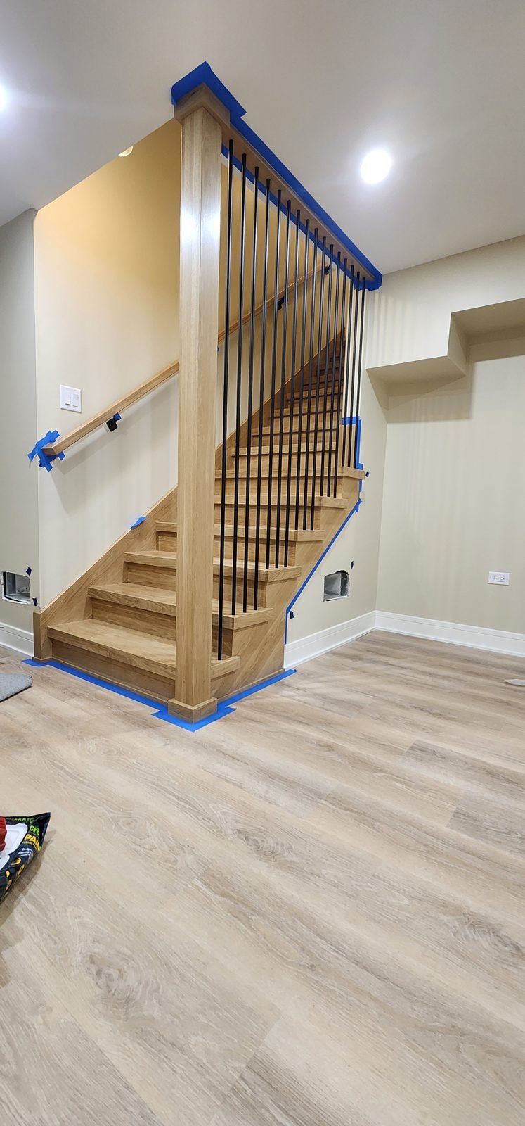 White oak staircase with box newel post and black iron spindles