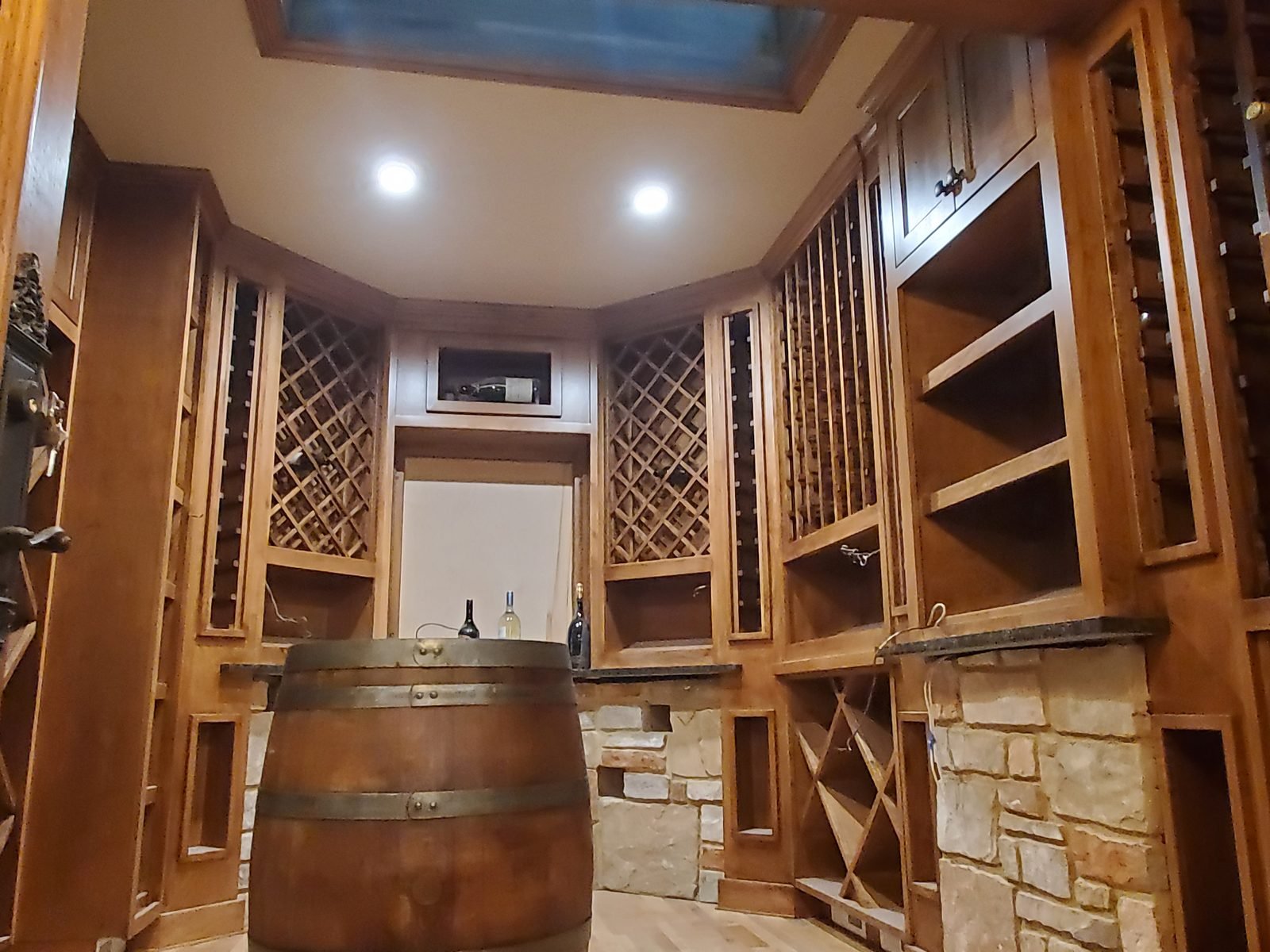 Wine cellar with diamond bin racking and stained cabinetry